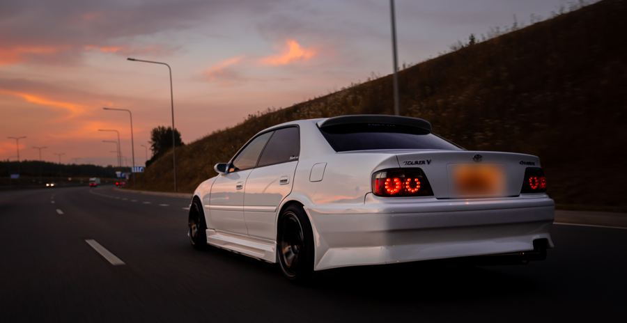 Round tail lights of the Toyota Chaser glowing at dusk