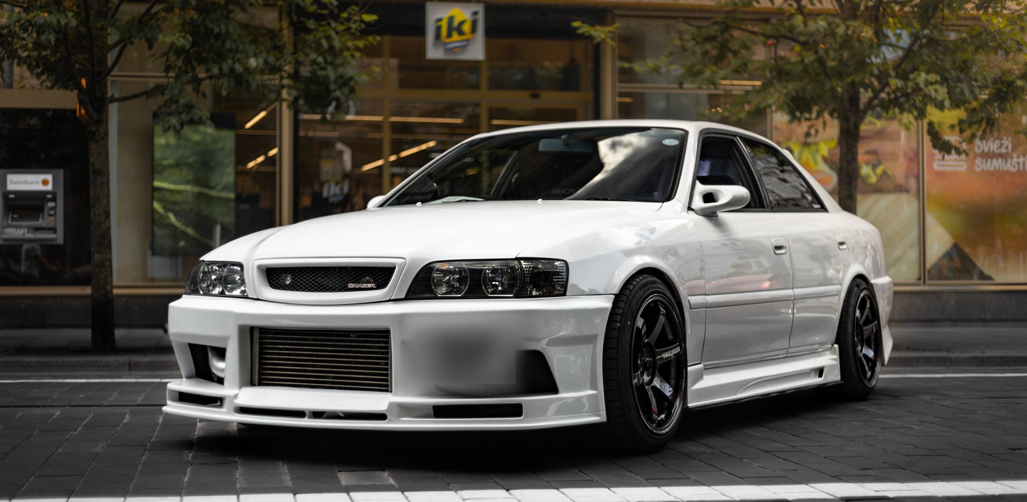 White Toyota Chaser JZX100 Tourer V with a front-mounted intercooler and black wheels