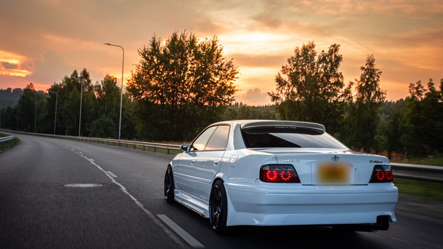 Toyota Chaser heading towards an orange sunset
