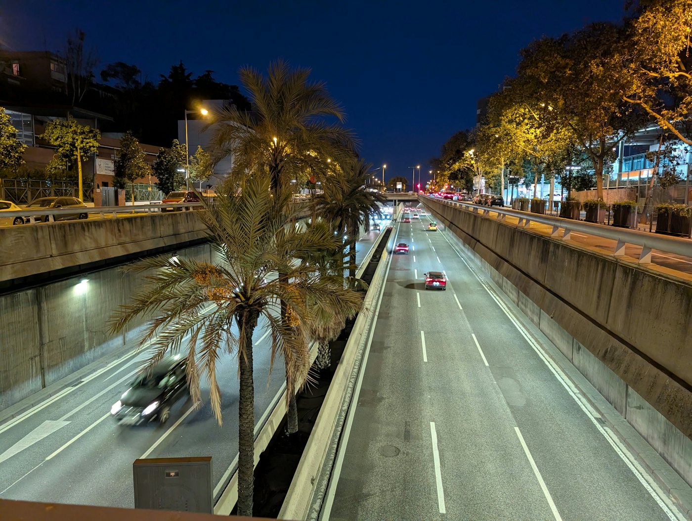 Barcelona ring road at night, lined with palm trees