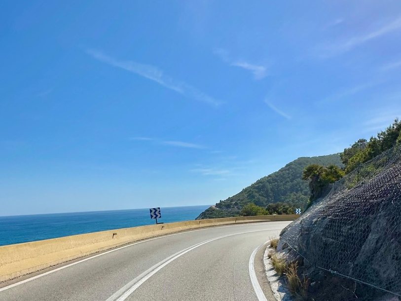 The Garraf coast road curving along the cliffs above the sea