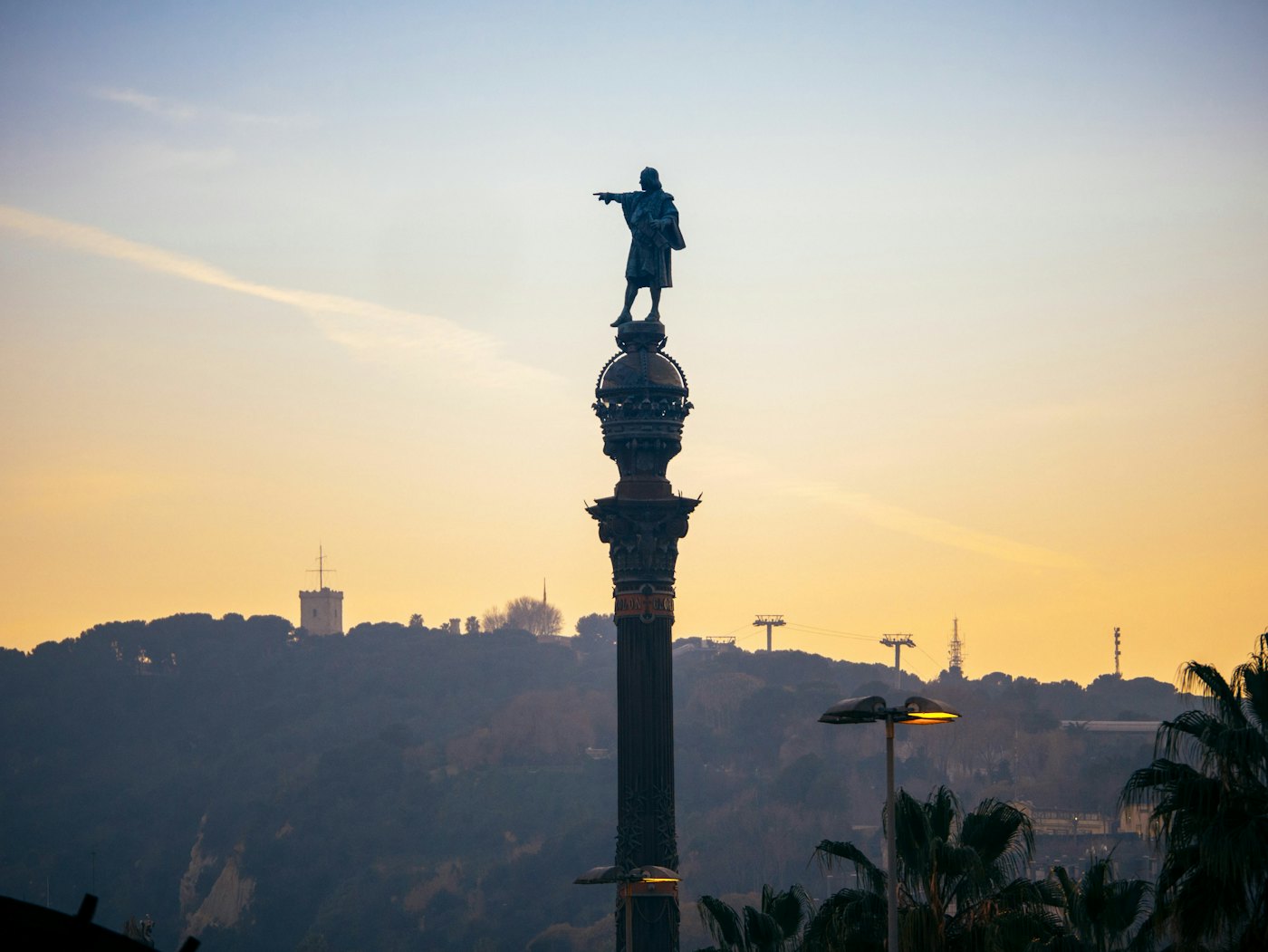 The Columbus Monument against a sunset sky