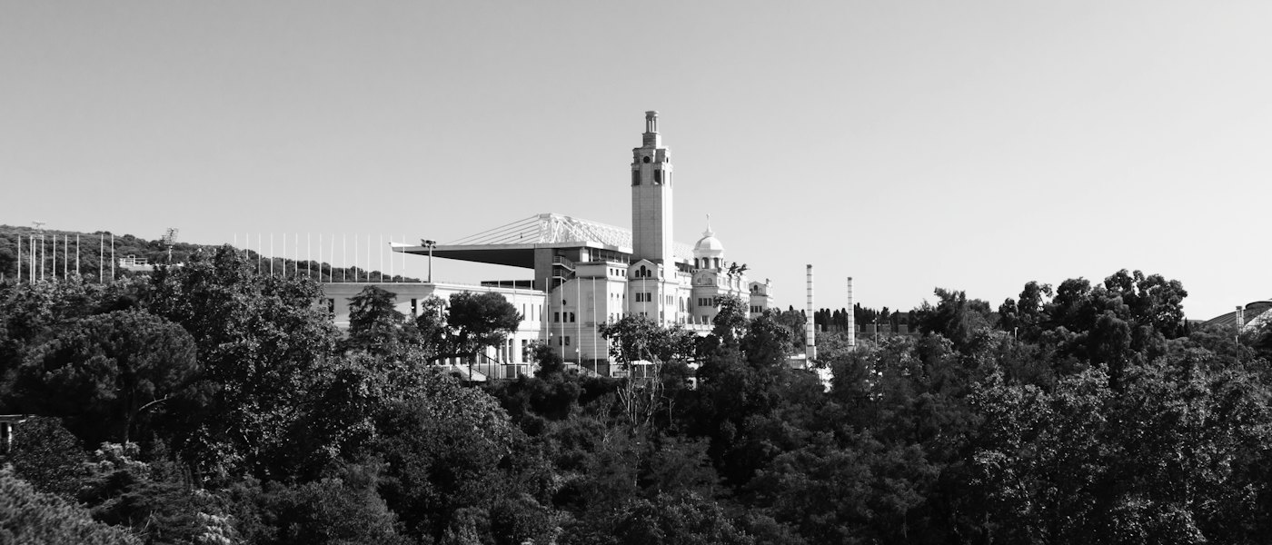 The tower of the Olympic Stadium on Montju&iuml;c above the trees