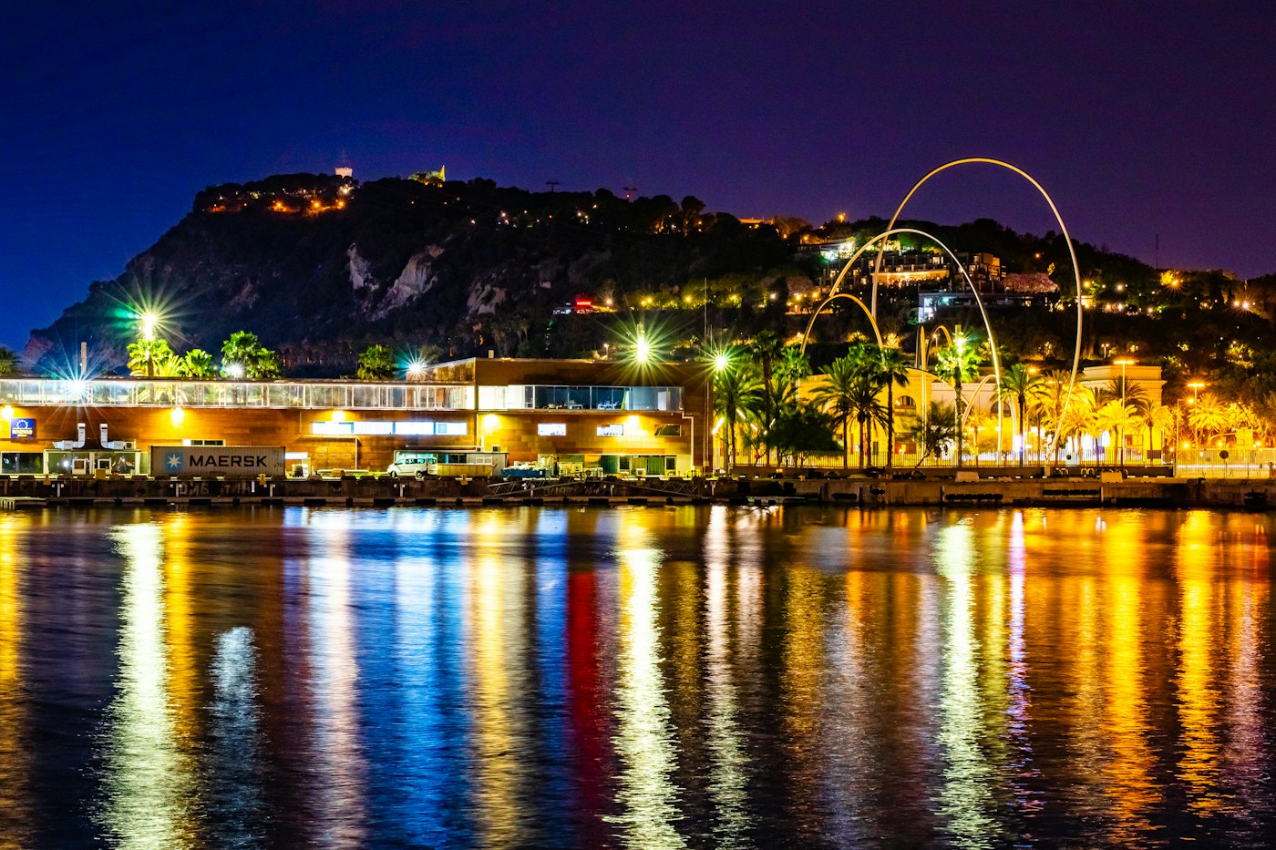 The port of Barcelona at night with Montju&iuml;c hill behind