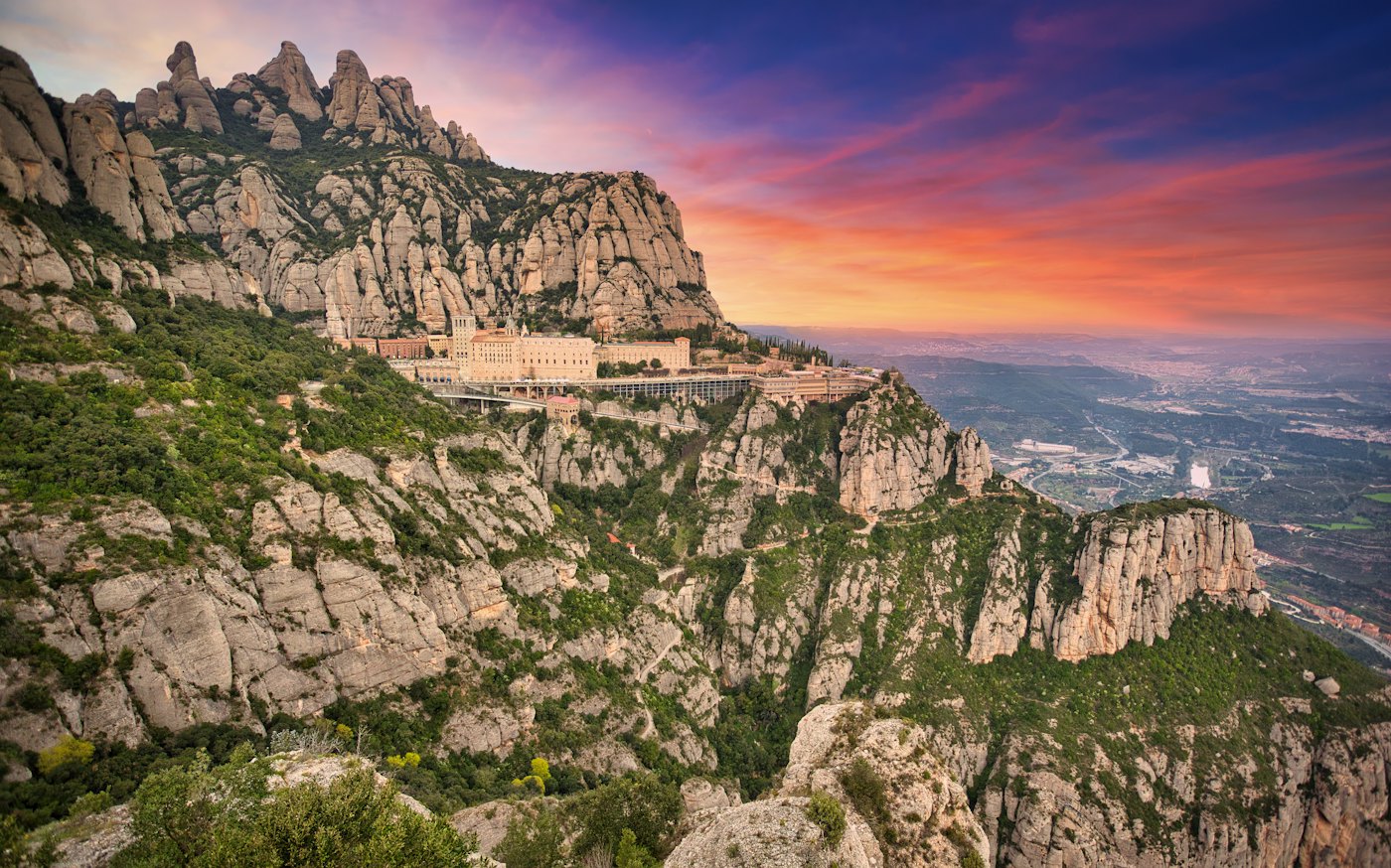Montserrat monastery below the peaks at sunset
