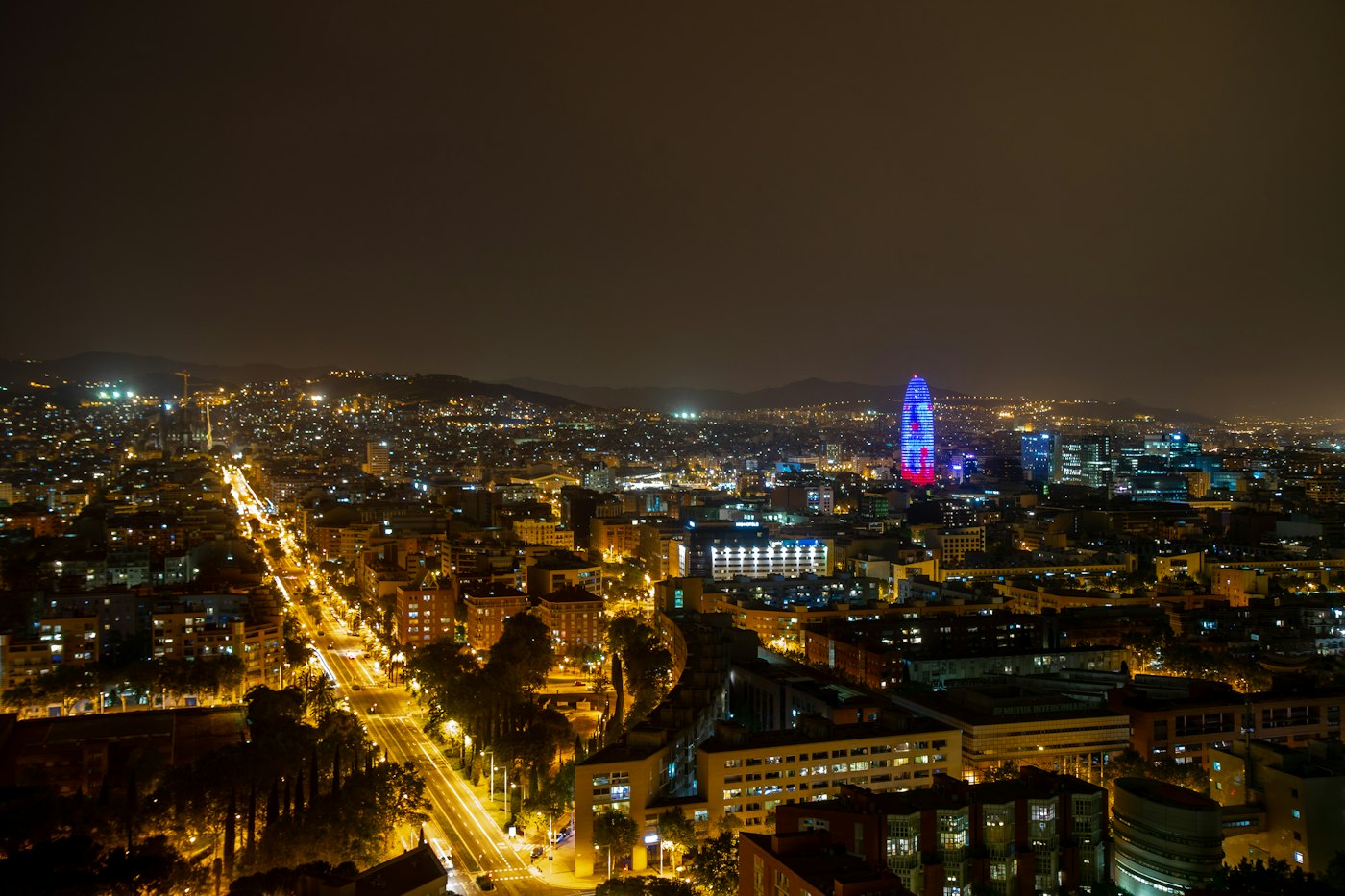 Barcelona at night, its avenues lit up