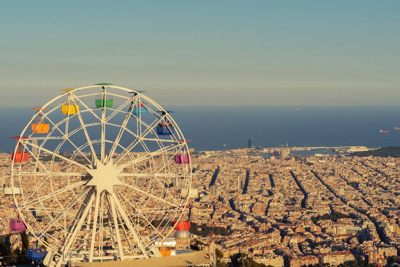 The Tibidabo Ferris wheel with Barcelona and the sea below