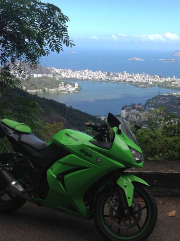 Green sport motorcycle at a lookout over the lagoon and the Zona Sul beaches in Rio de Janeiro