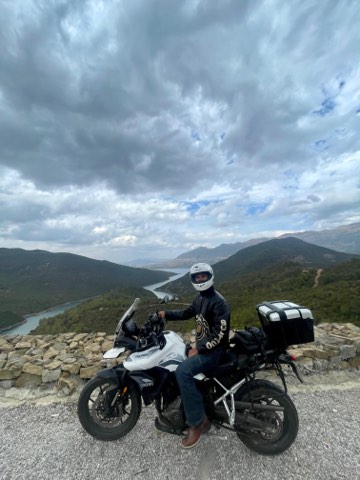Rider at a mountain viewpoint over green sierras in southern Spain